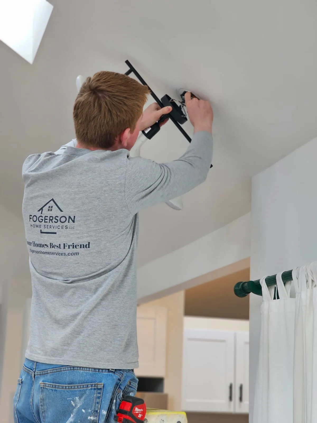 Handyman working on interior light fixture